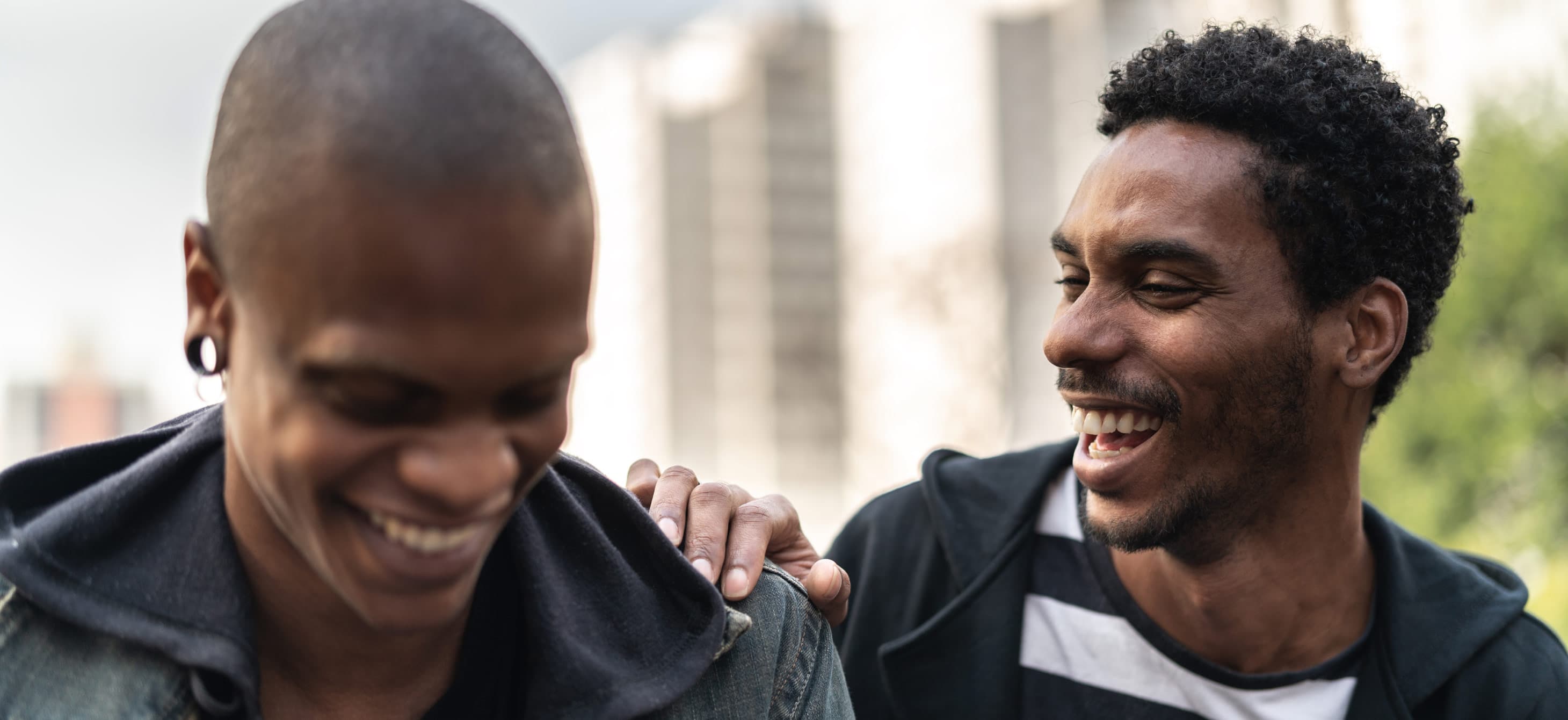 two Black men smiling at each other