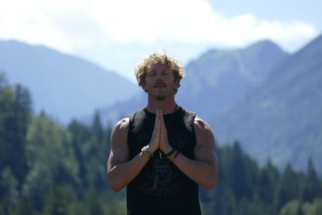 A man serenely prays with a look of gratitude on his face