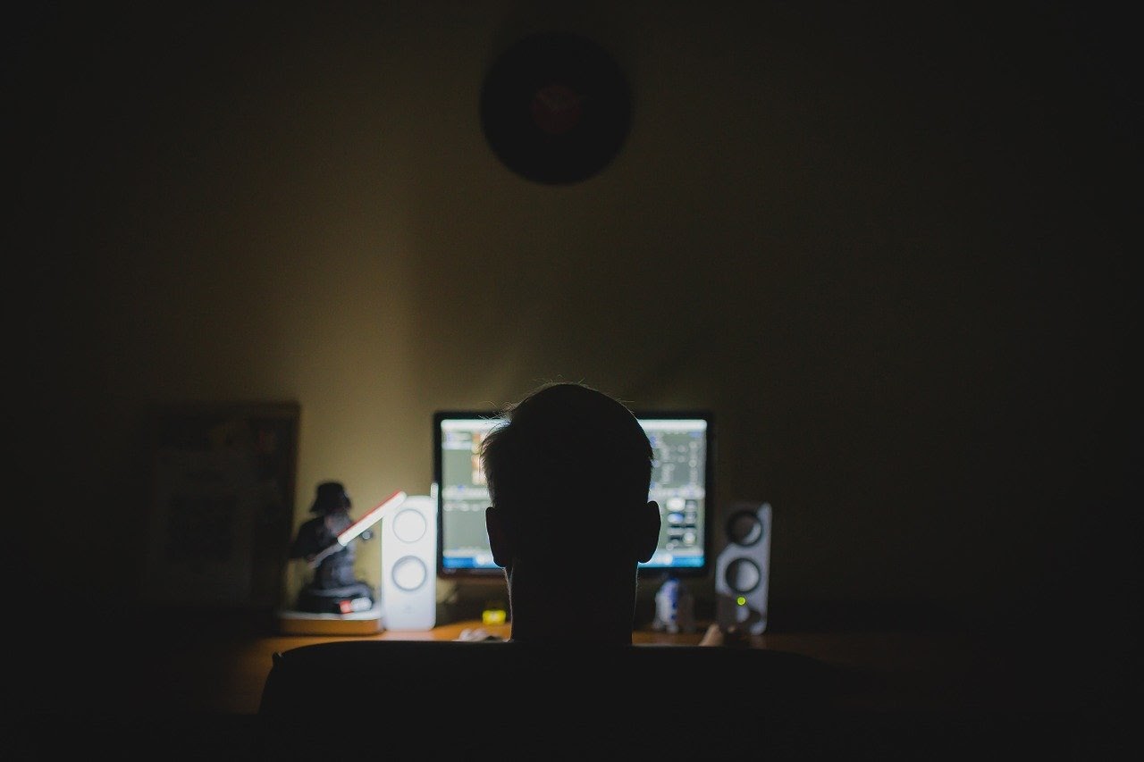 Person watching a computer late at night