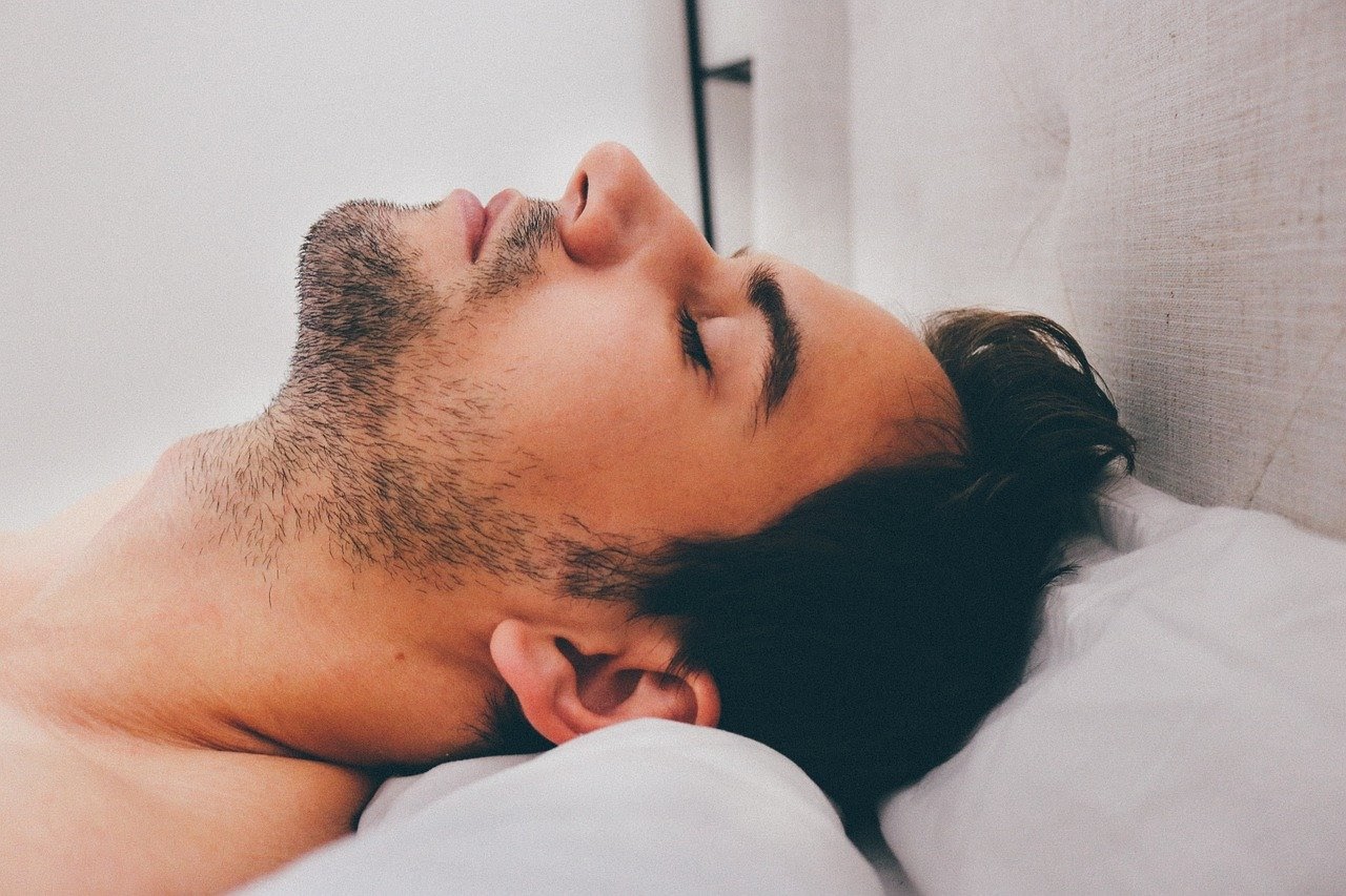 Man lying down on a bed