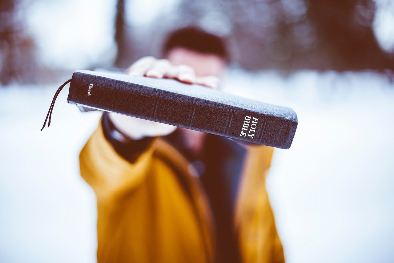 Man holding the Holy Bible