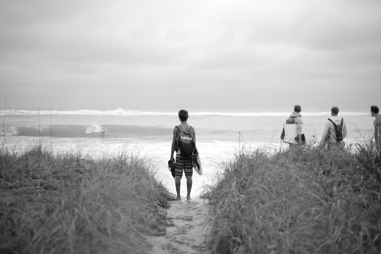 a surfer looking out at the waves in the ocean