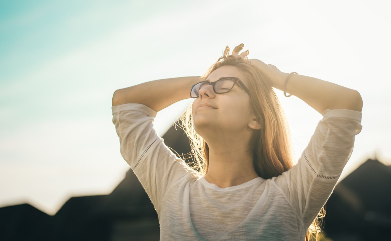 Women with head turned to the sky with eyes closed