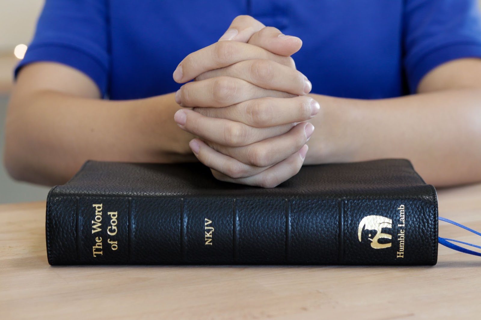 Hands resting on bible