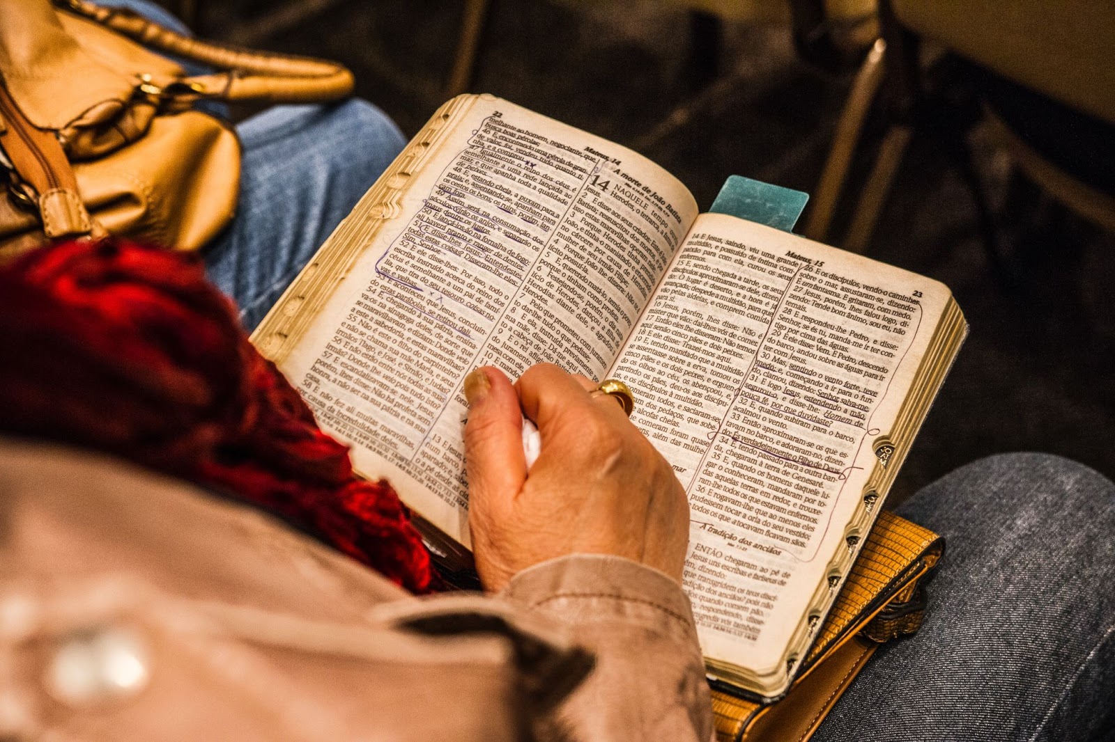 Person reading scriptures that are marked up.