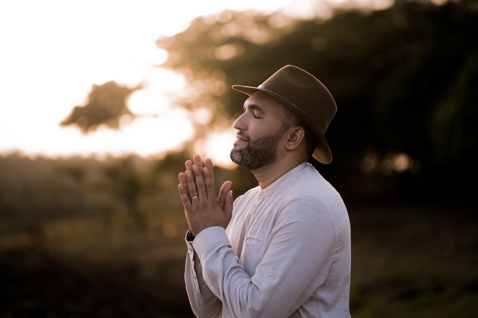 man praying in a field