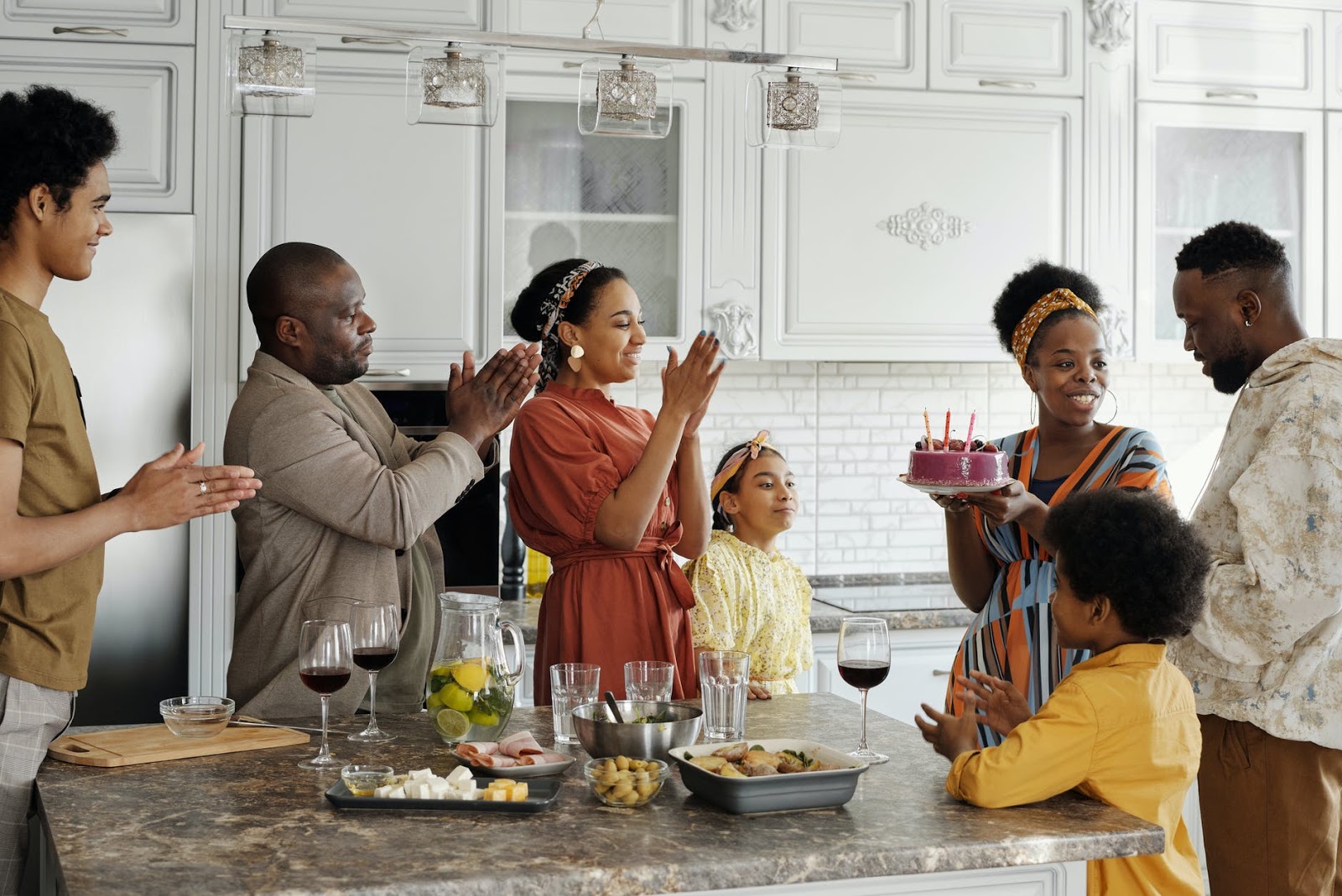 Family gathered around food to celebrate birthday