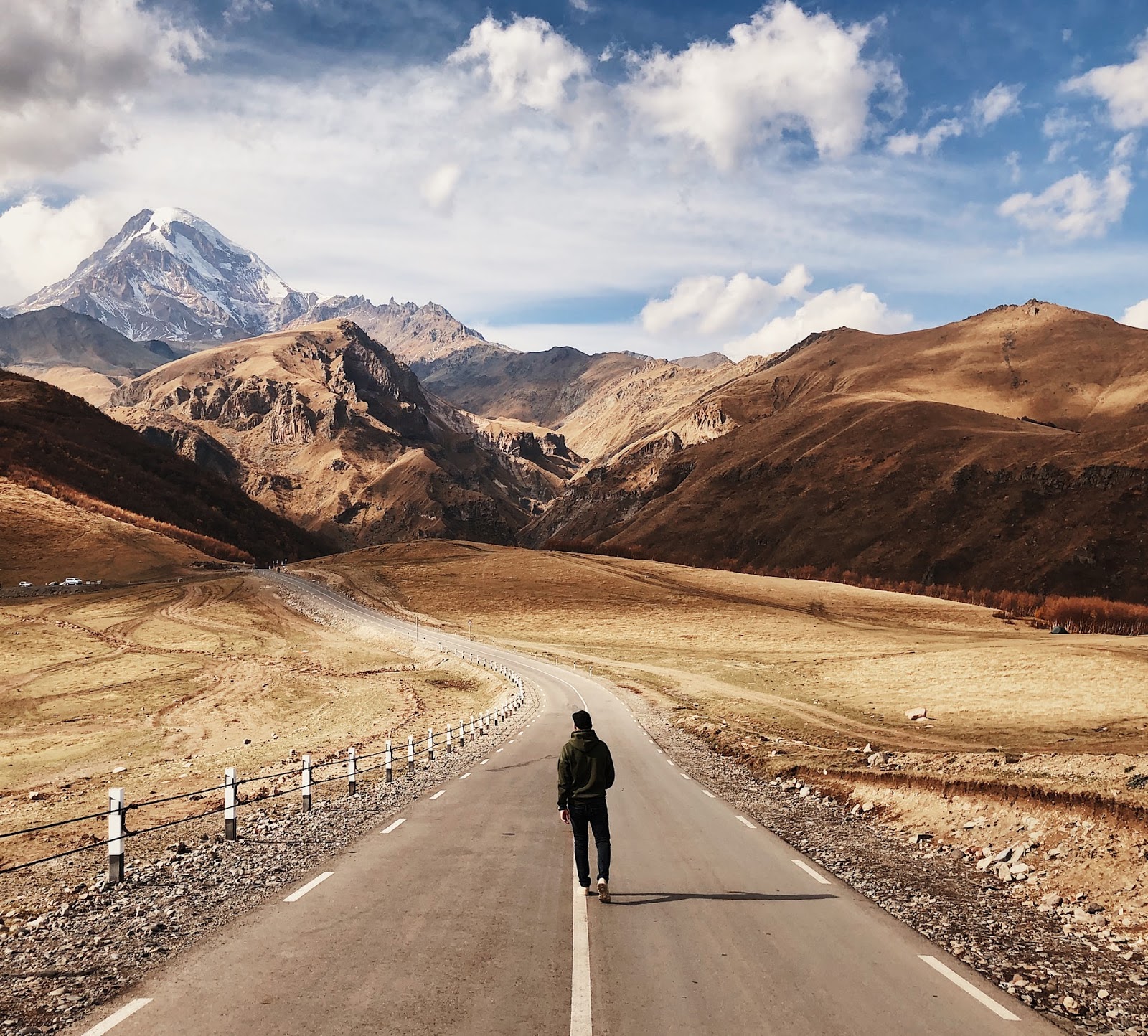 man walking on a road