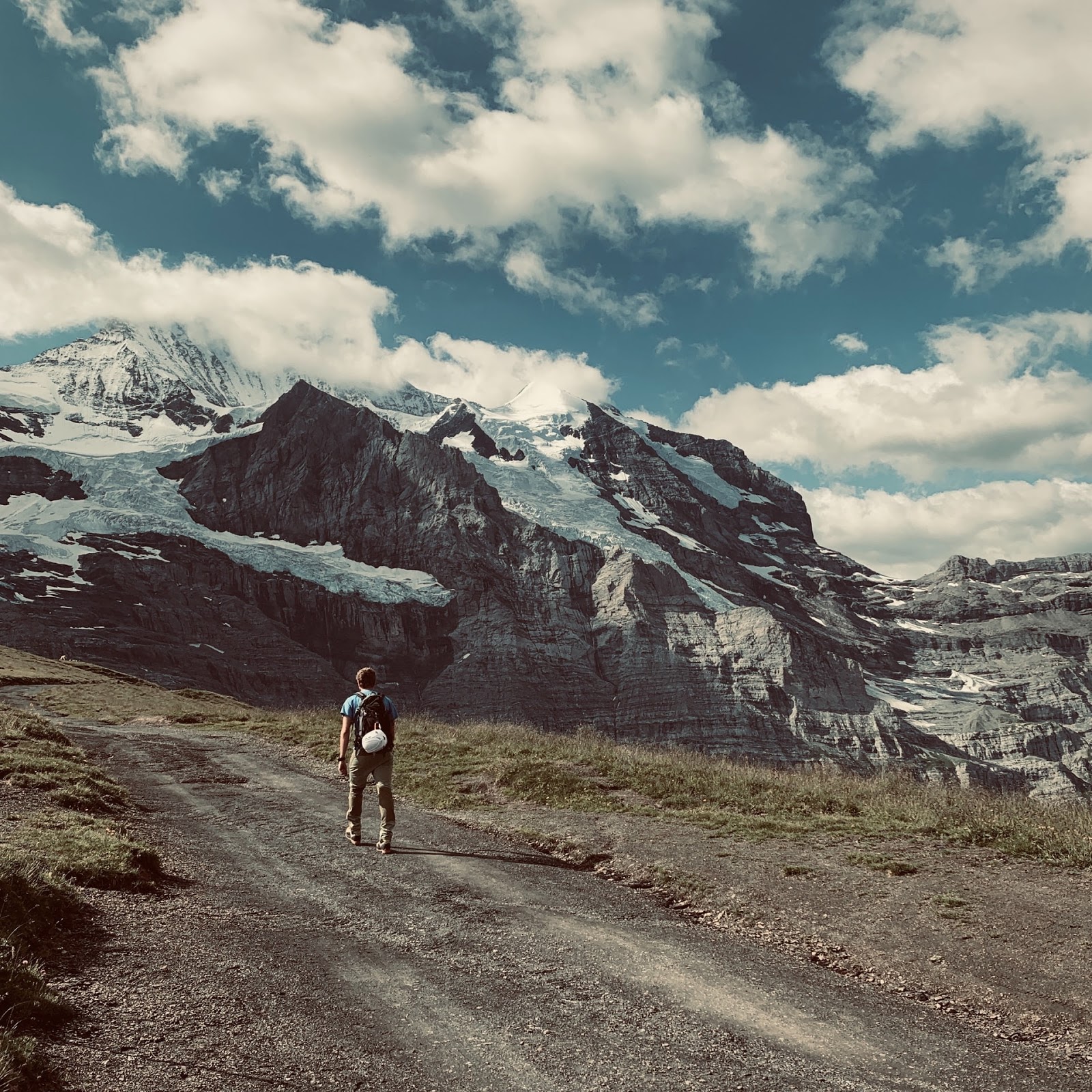 man walking next to mountains