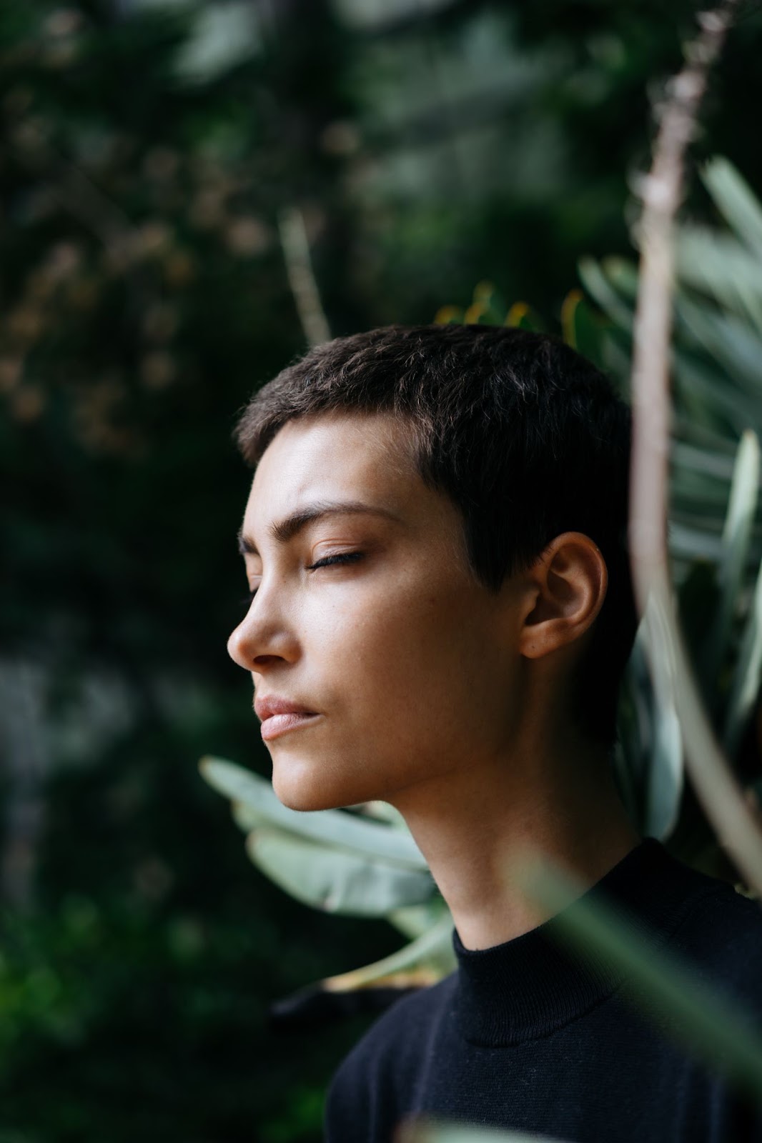 A person sits, quieting their mind in meditation