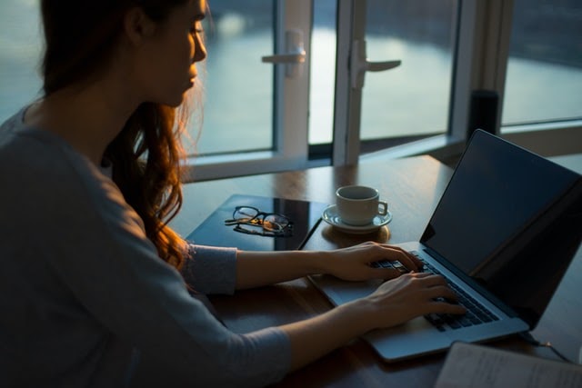 Woman typing on laptop at work