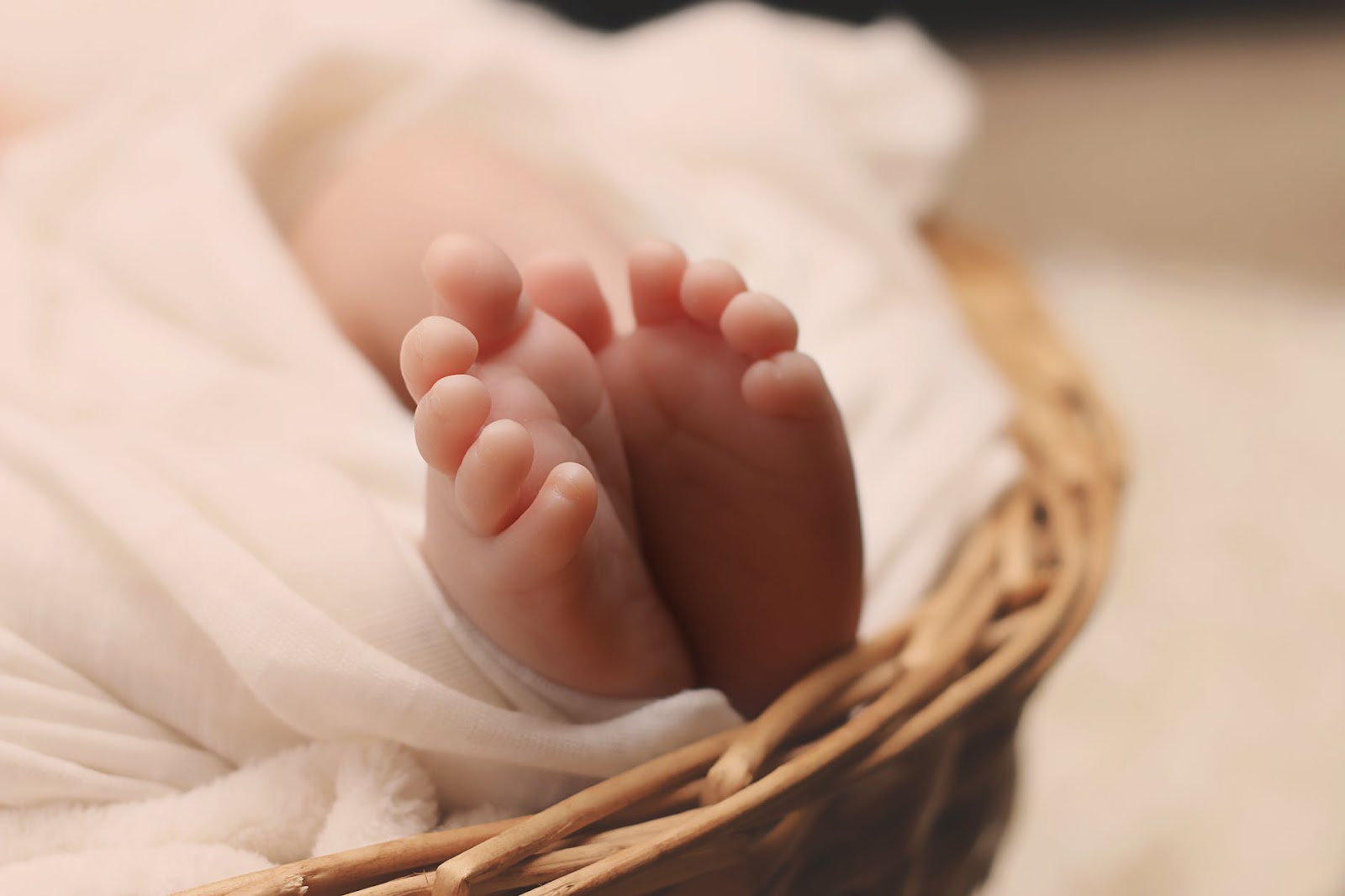 Baby feet in a wicker basket