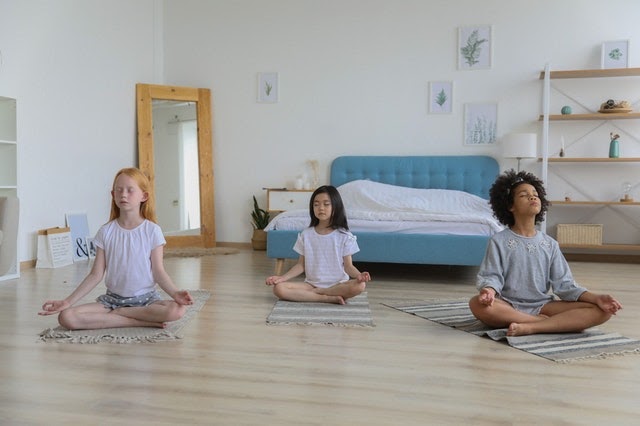 Three children meditating together