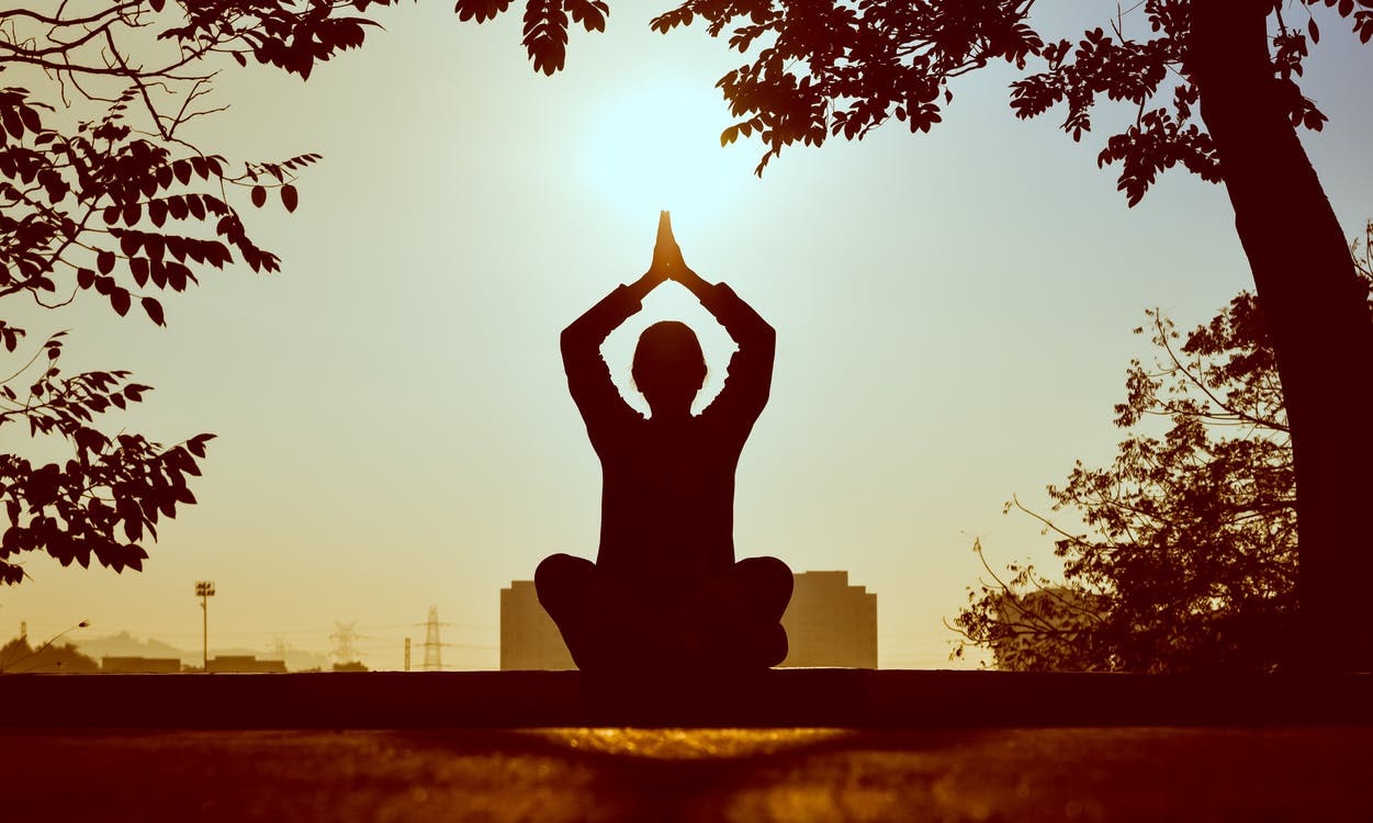 A man sits outside meditating