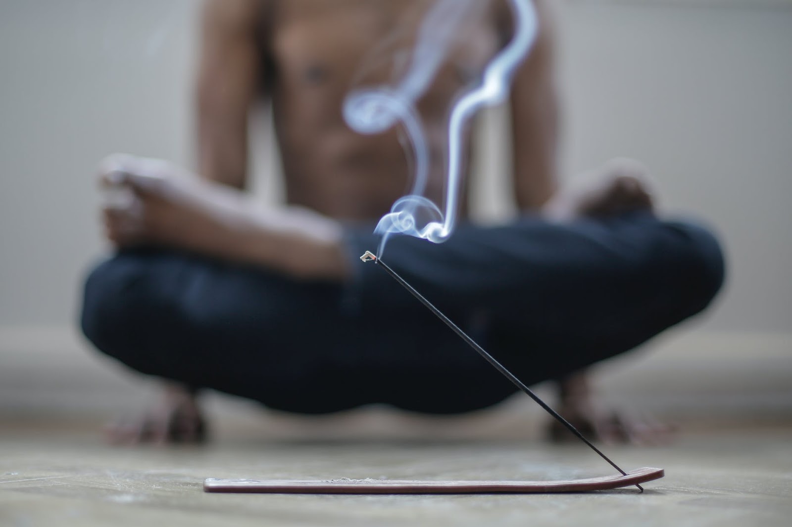 Man meditating with incense burning