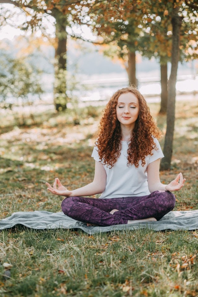 Young woman meditating in nature