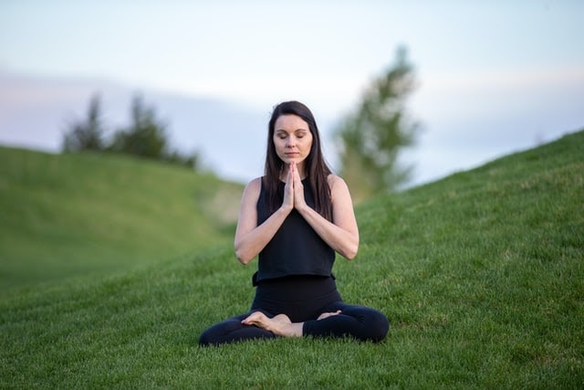 Woman meditating in a field