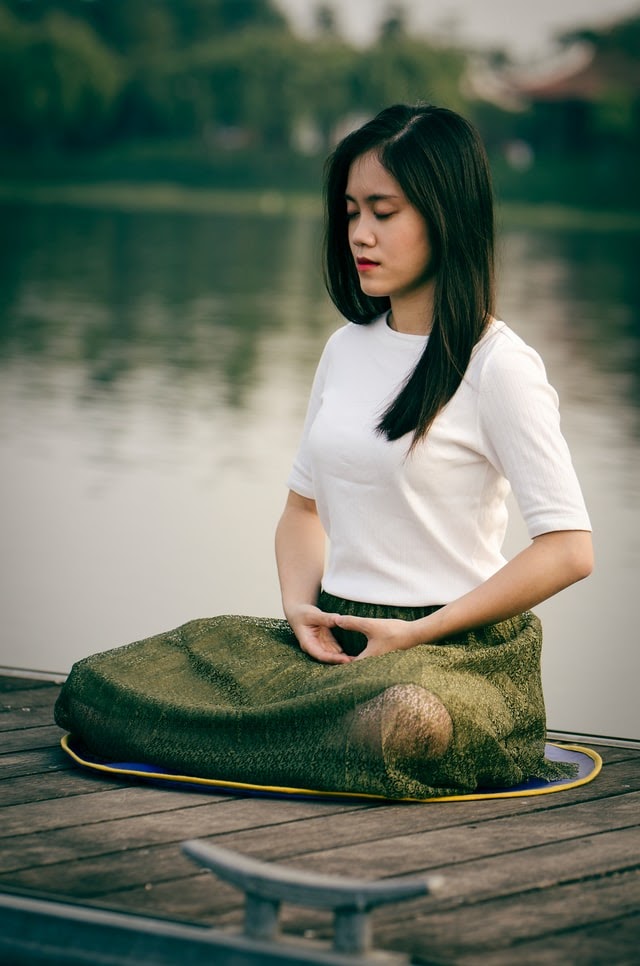 Woman meditating outdoors