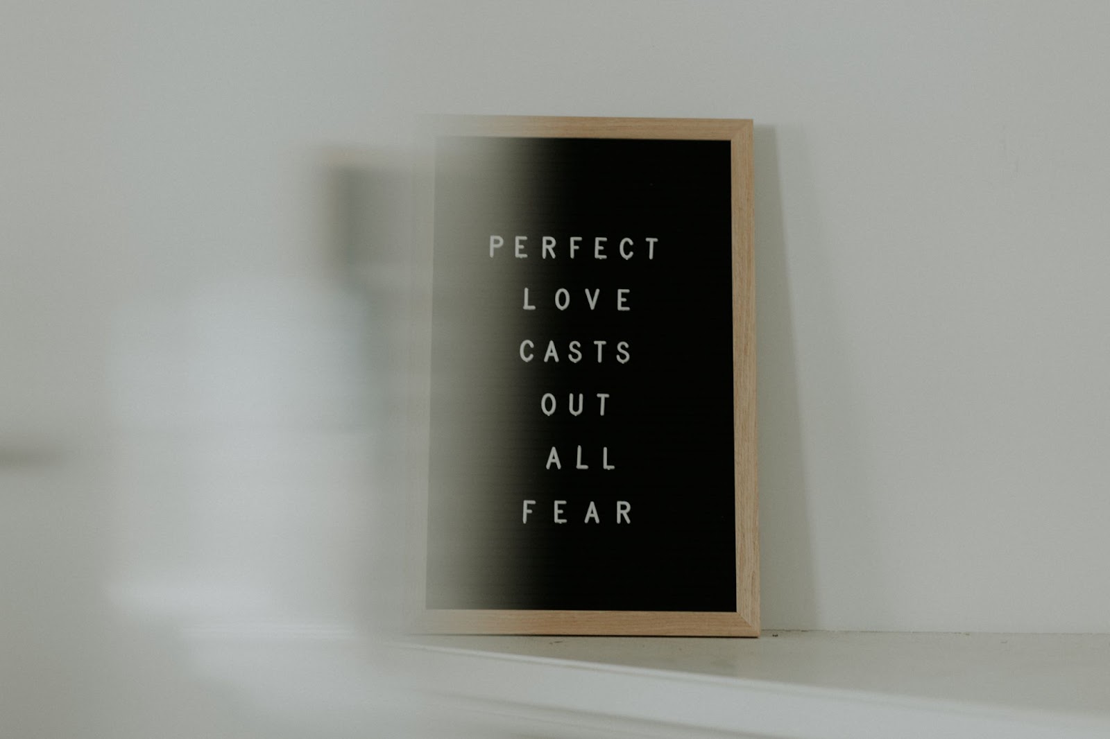 'Perfect love casts out all fear' spelled out on letter board