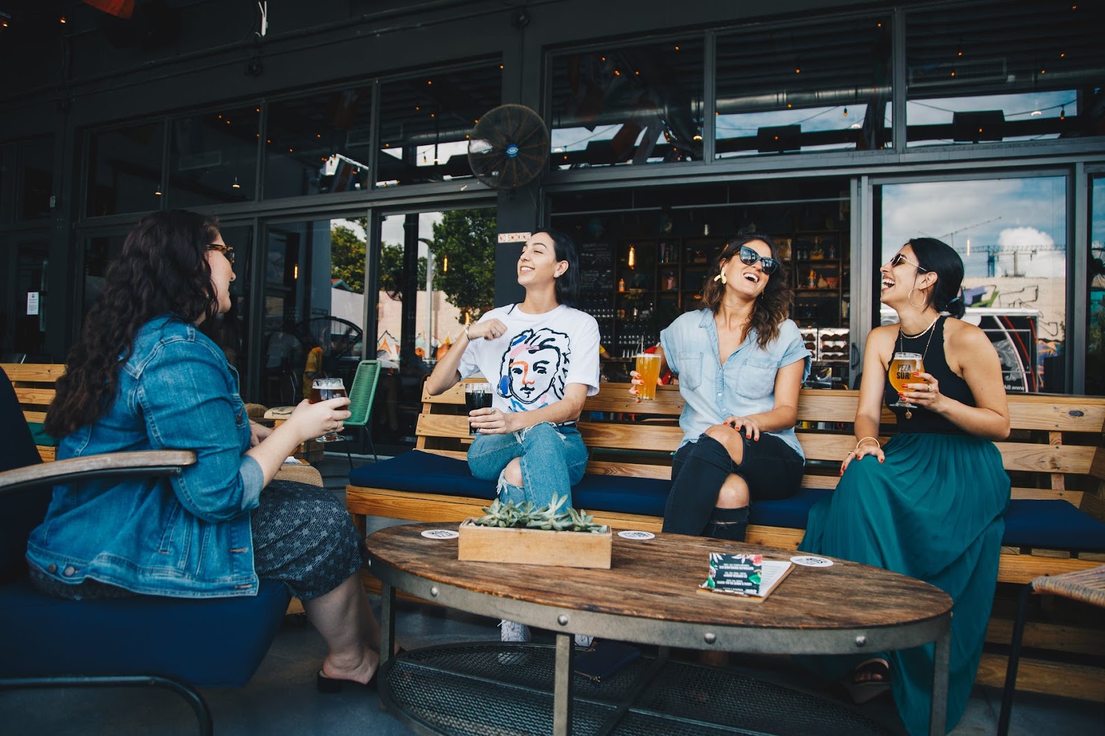 Four women gathered around a table talking
