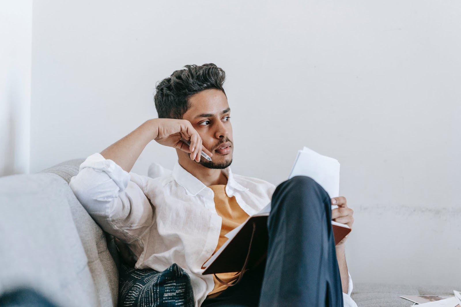 Man writing on the couch alone