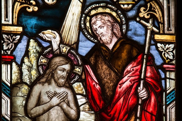 Stained glass window showing the Baptism of Jesus