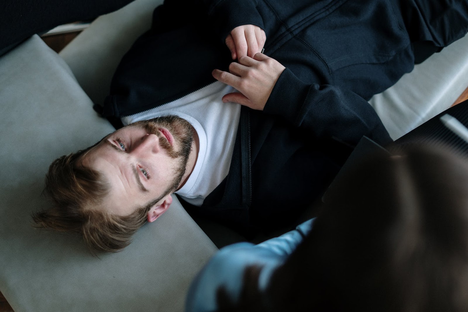 Man alone on couch in contemplation