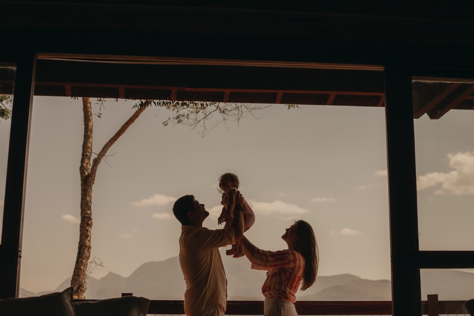a mother and father holding a baby