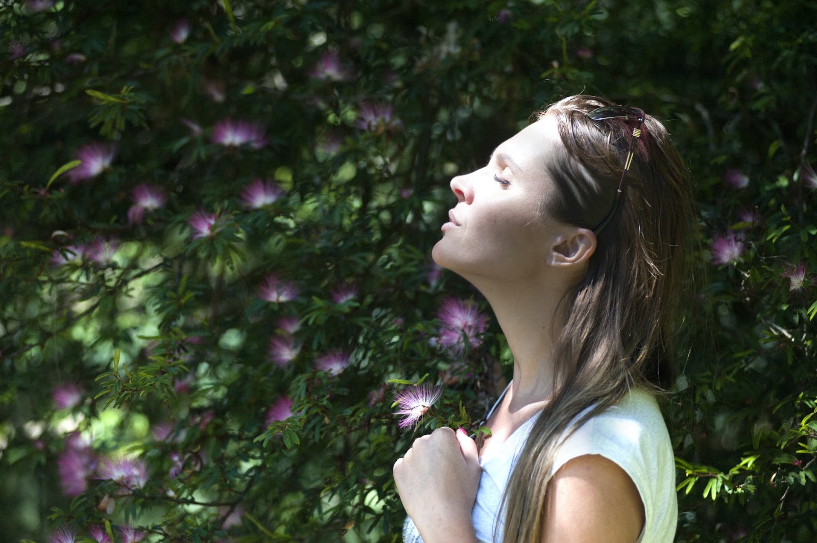 Woman in sunshine with flowers