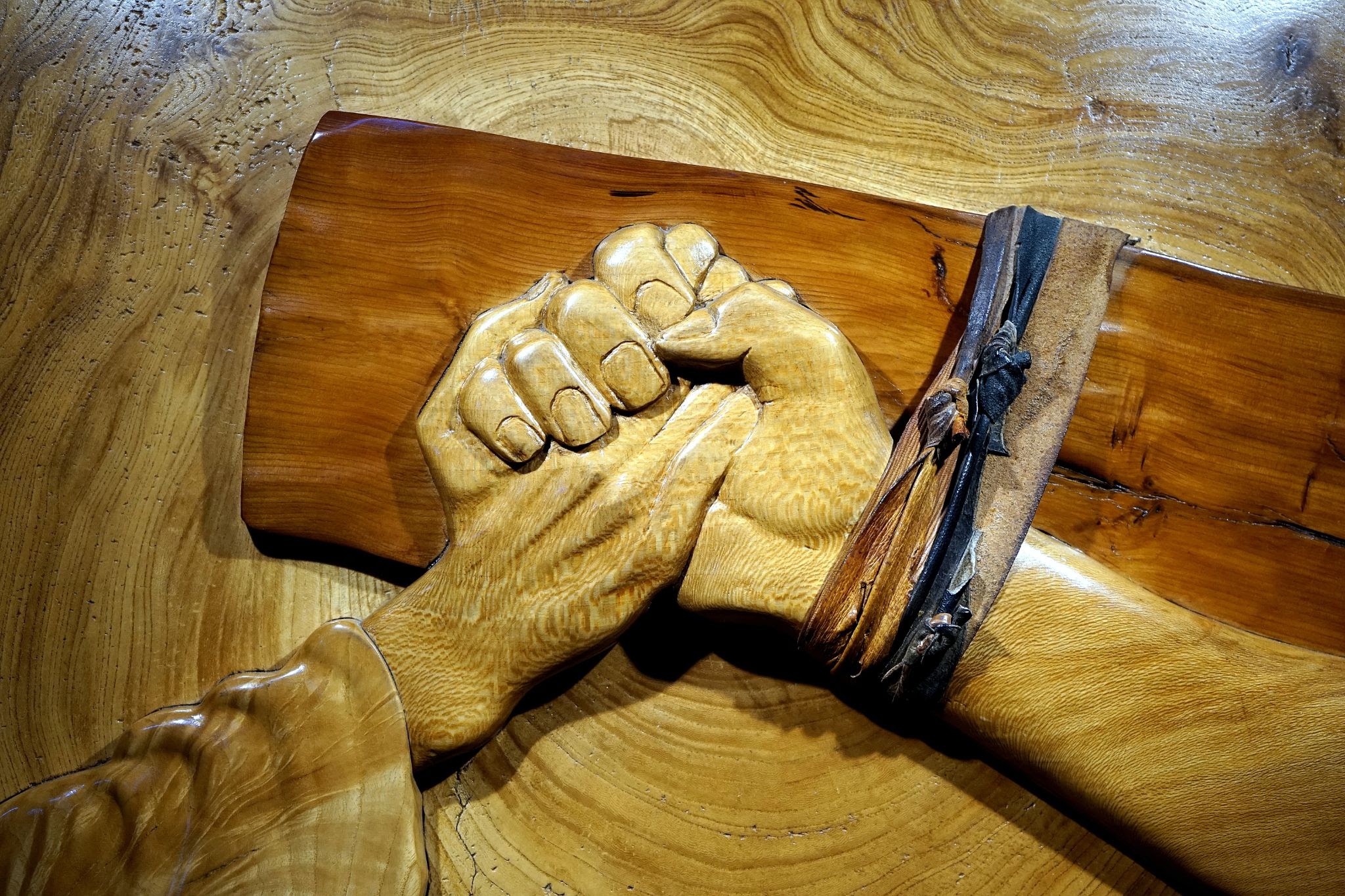 Jesus' hand grasping another, pinned to the cross