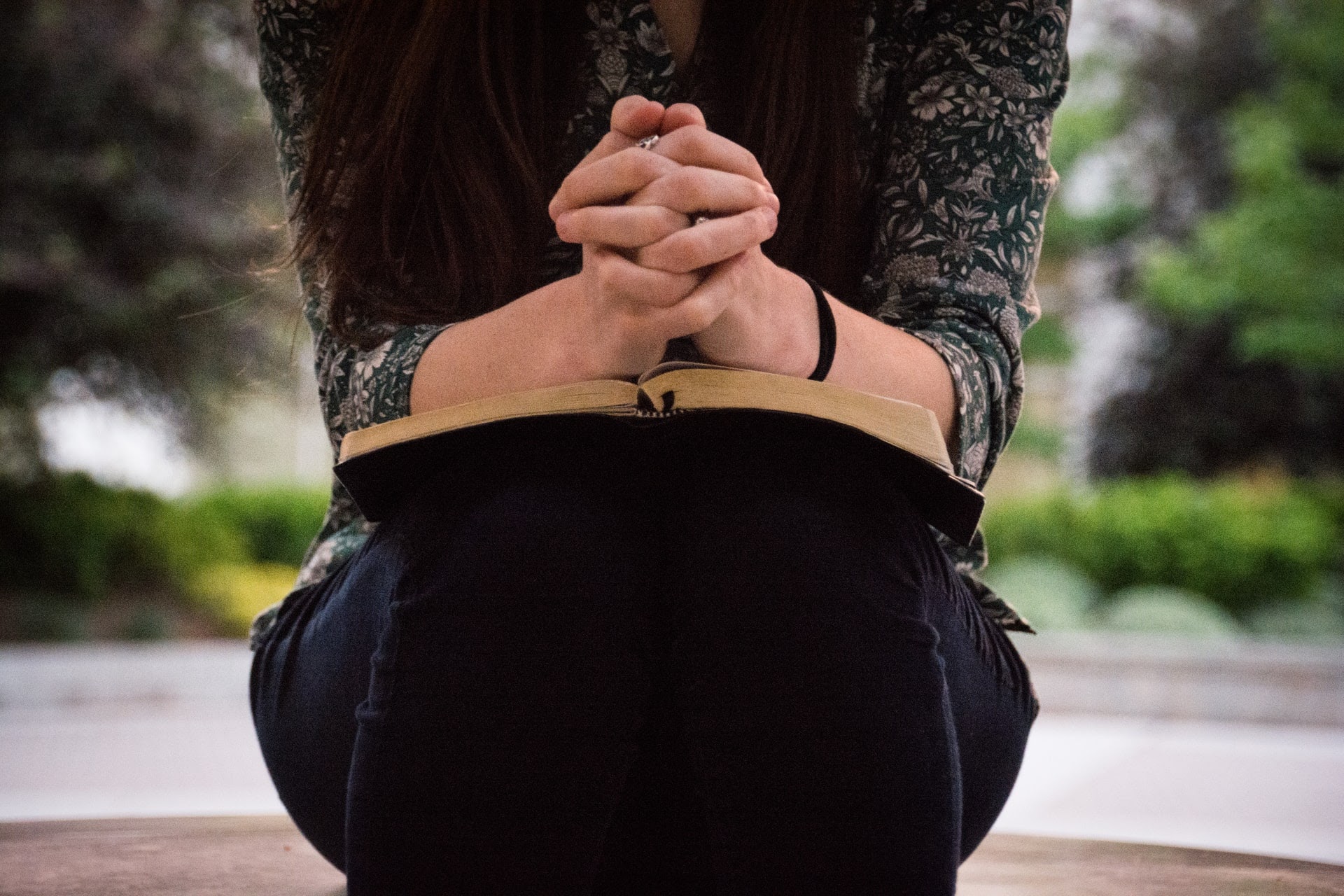 a person sitting with a Bible in their lap