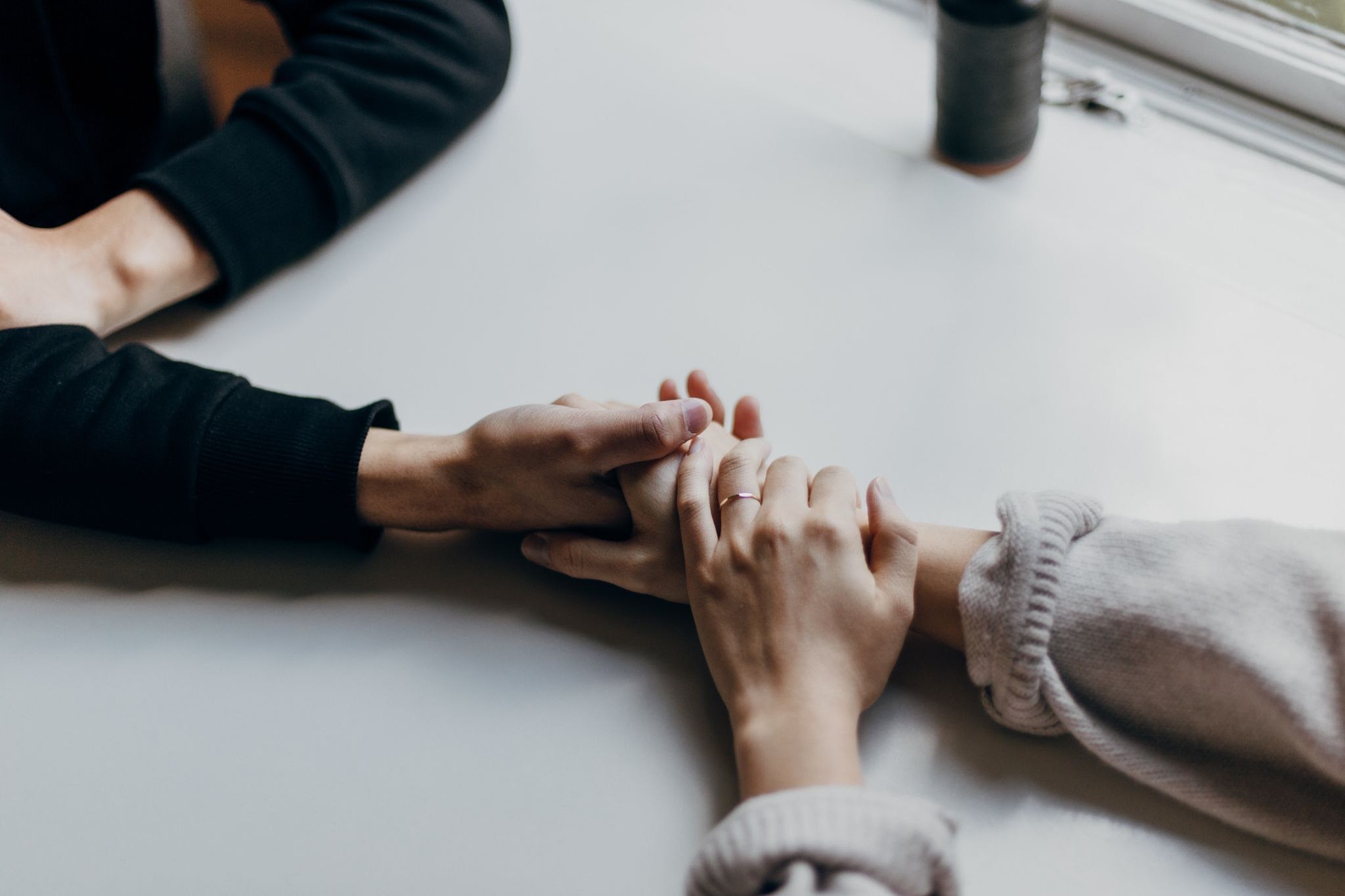 Supporting hand holding between two friends