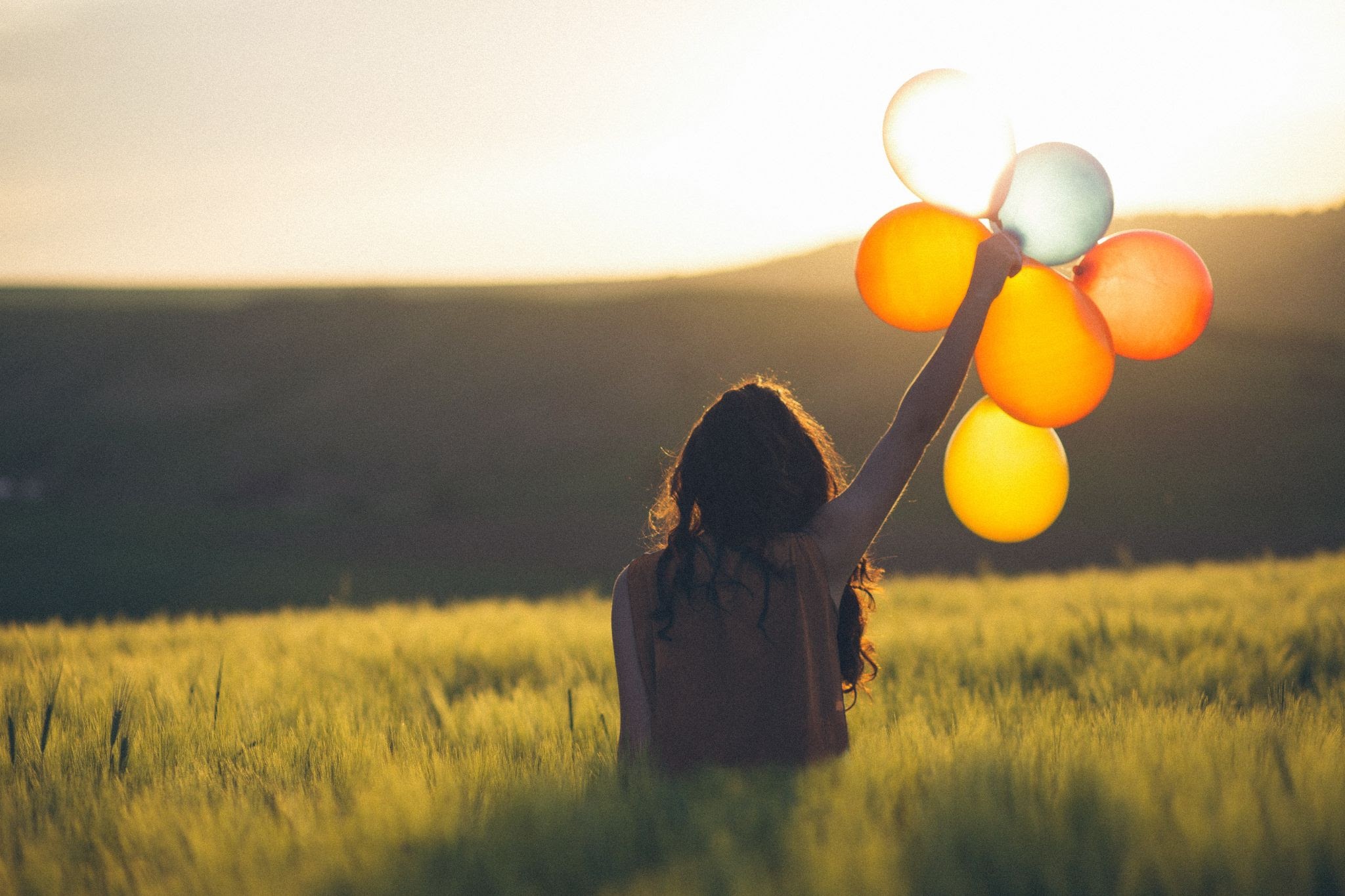 an-image-of-a-woman-with-balloons