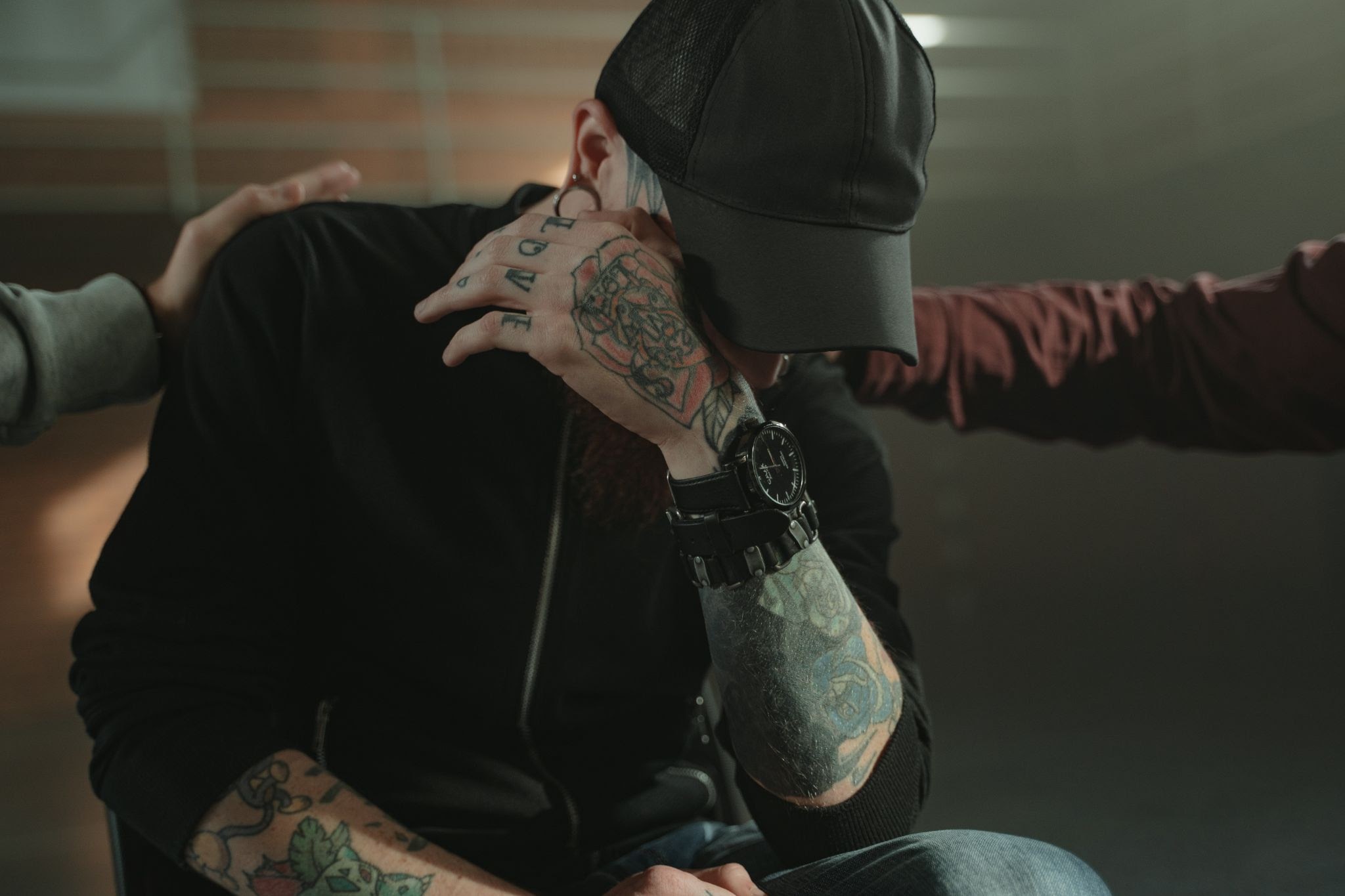 People consoling a man
