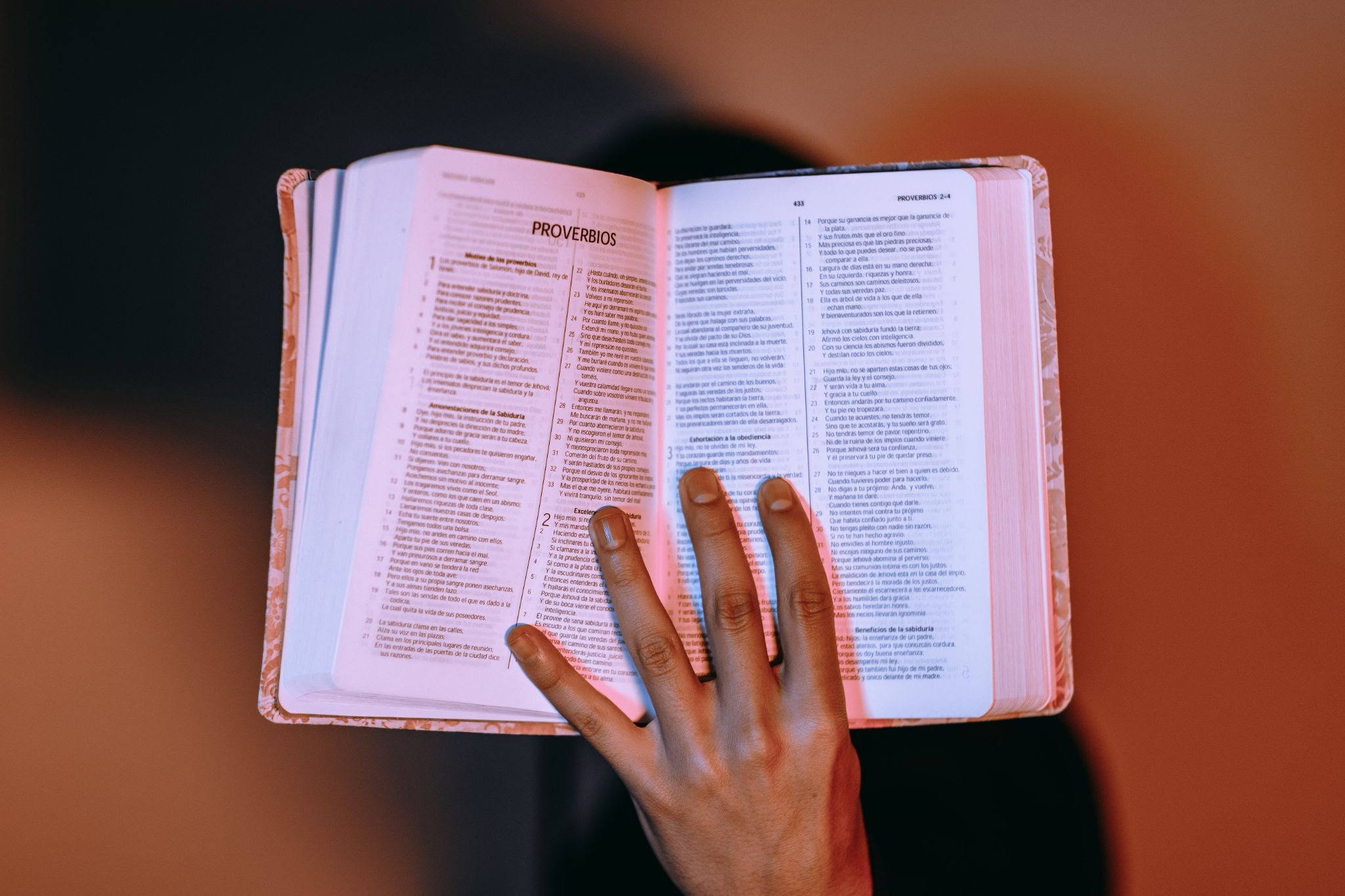 hand on open Bible