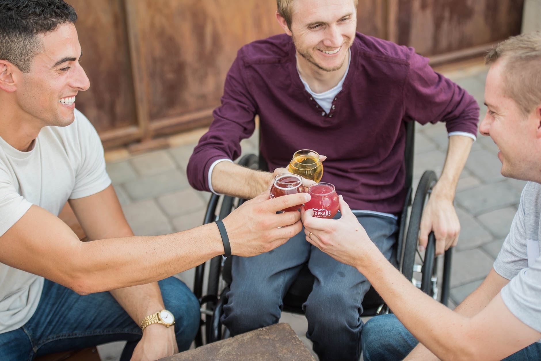 Three men having drinks outside