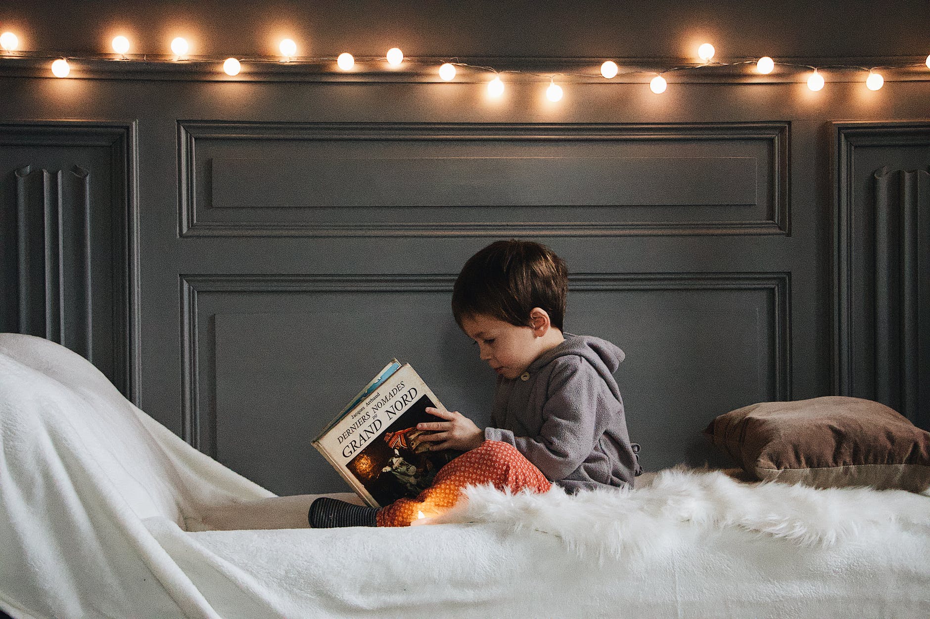 little boy reading before bed