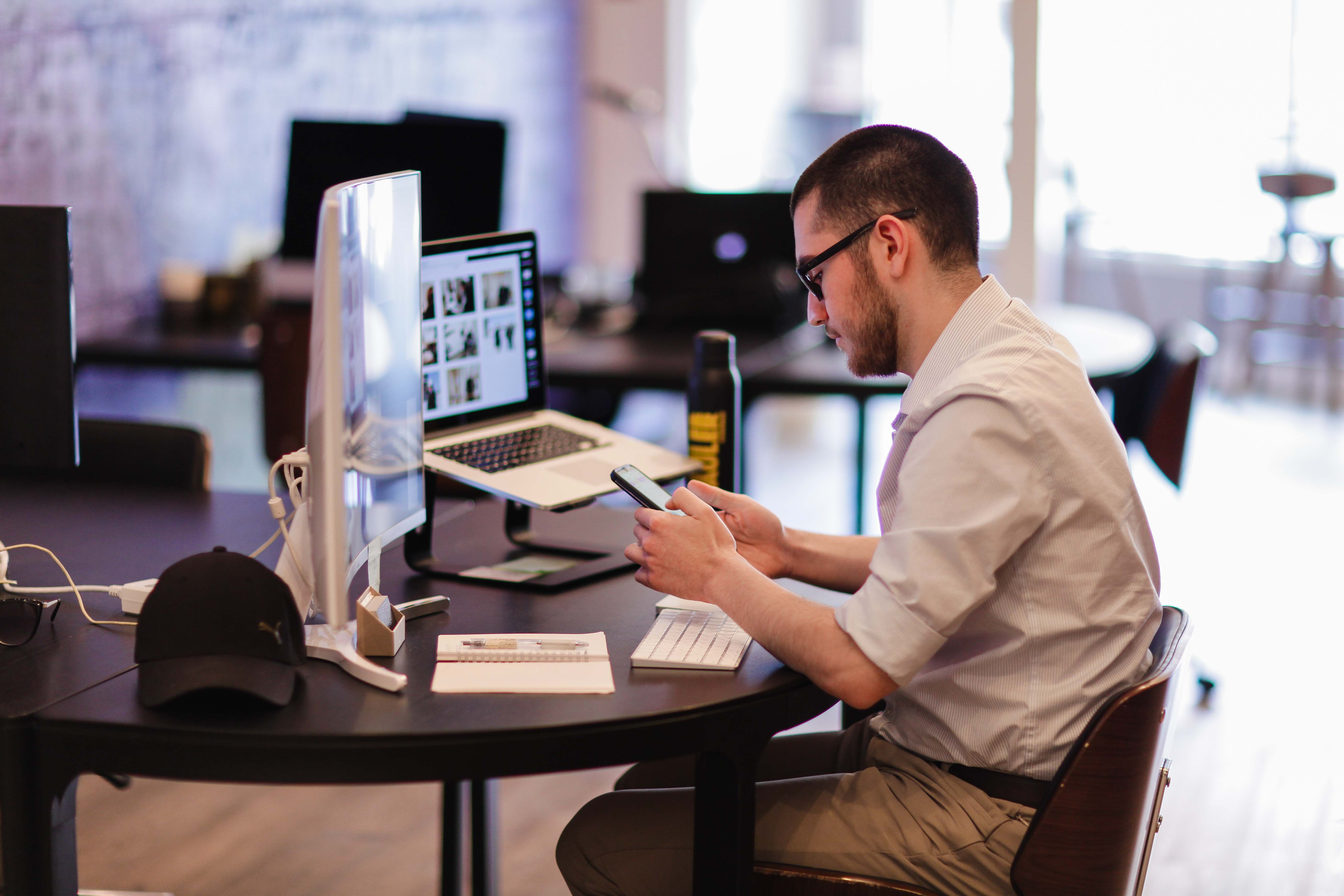 Man sitting at desk using phone