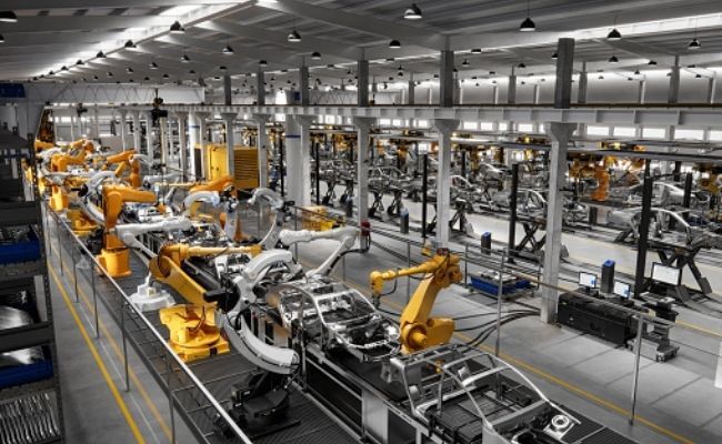 This is an image showing cars in line for production.
