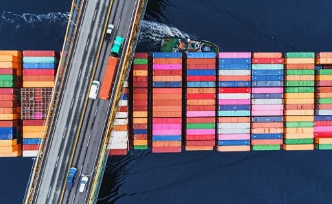 This is an image depicting a cargo ship with containers filled in different colors