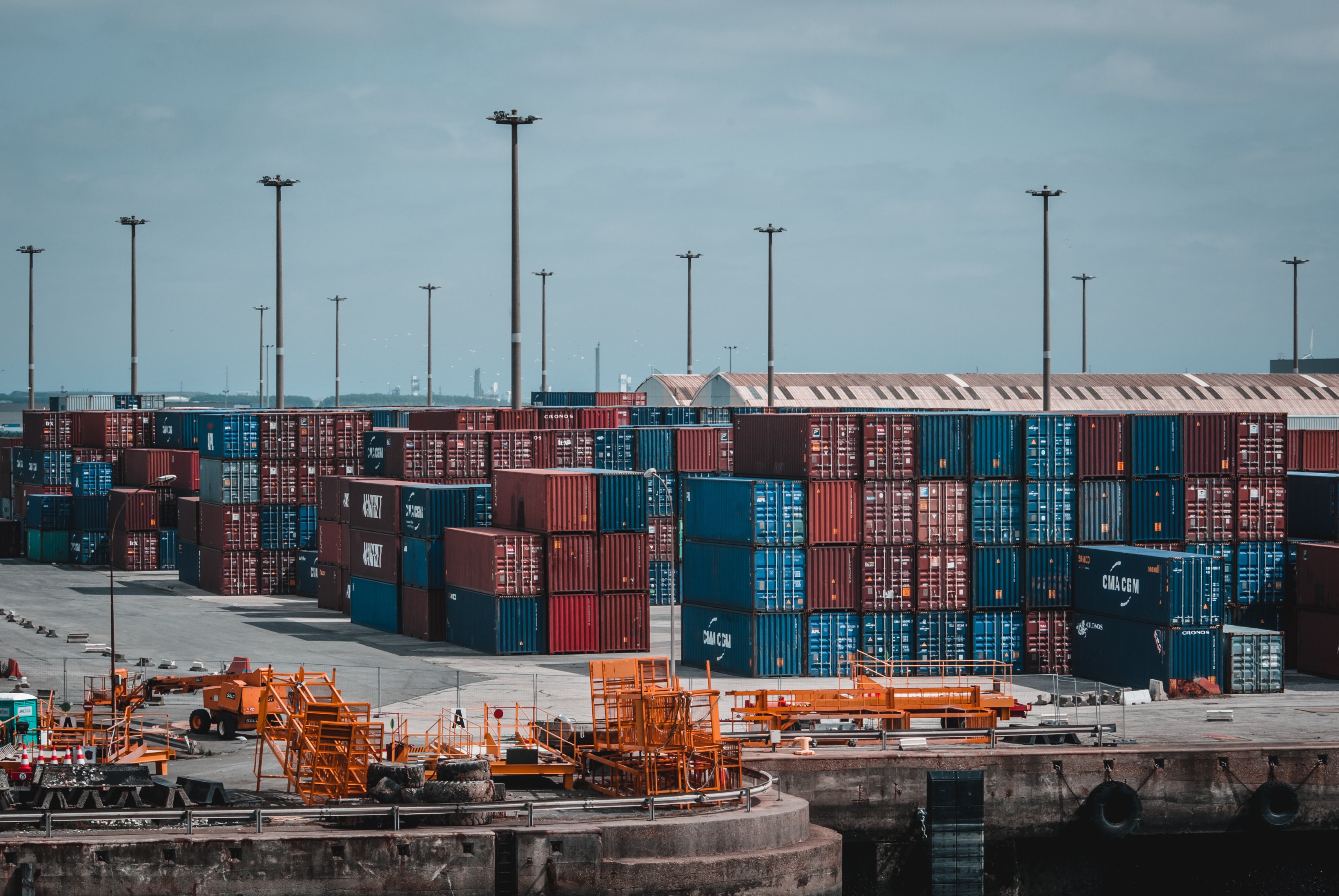 THis is the image containing a huge number of containers kept on the port which are meant to be transported trhough a shipping vessel.