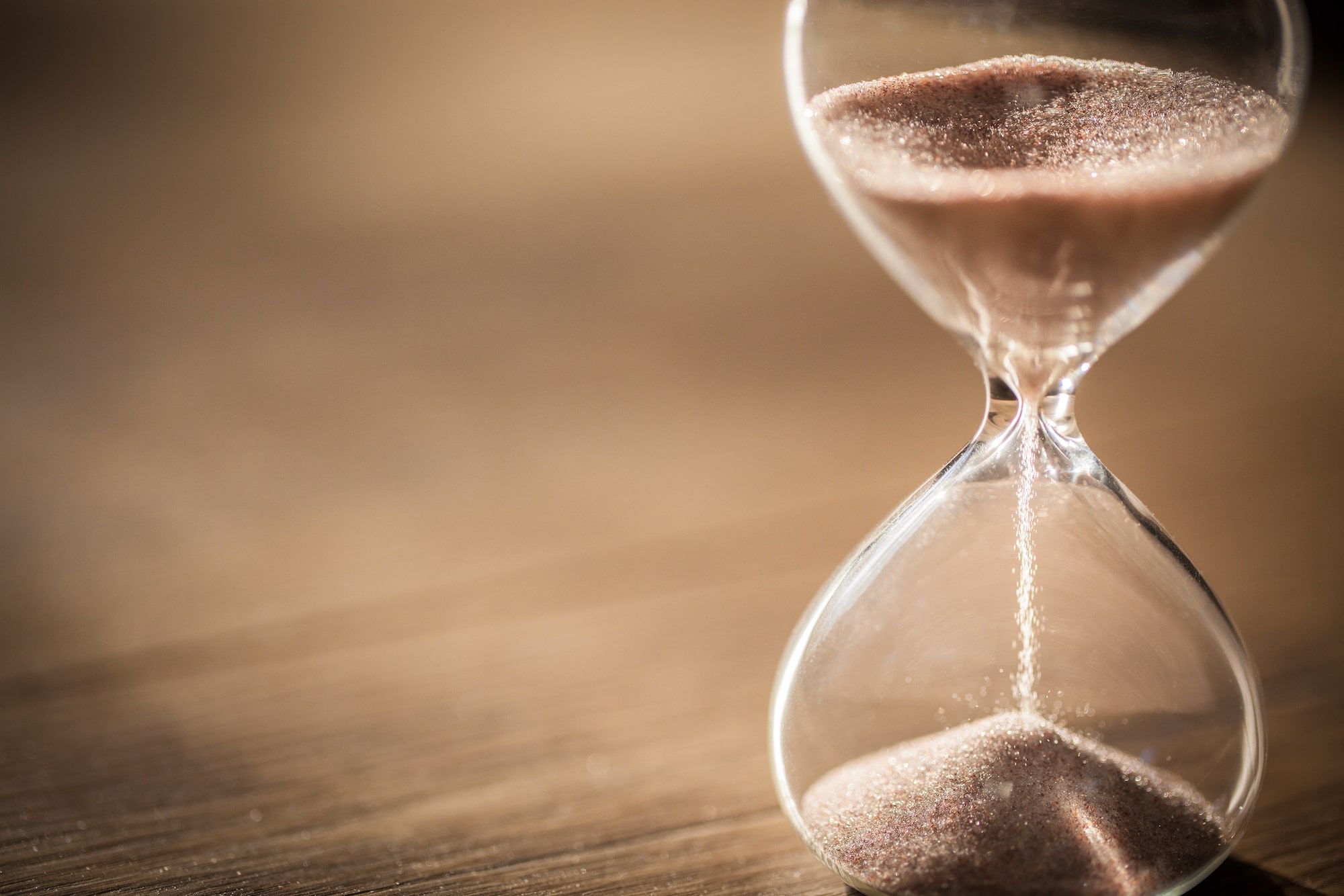 Sand running through an hour glass