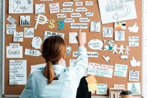 A woman looking at different aspects of marketing.