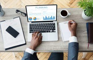A person making business plans based on analytics.