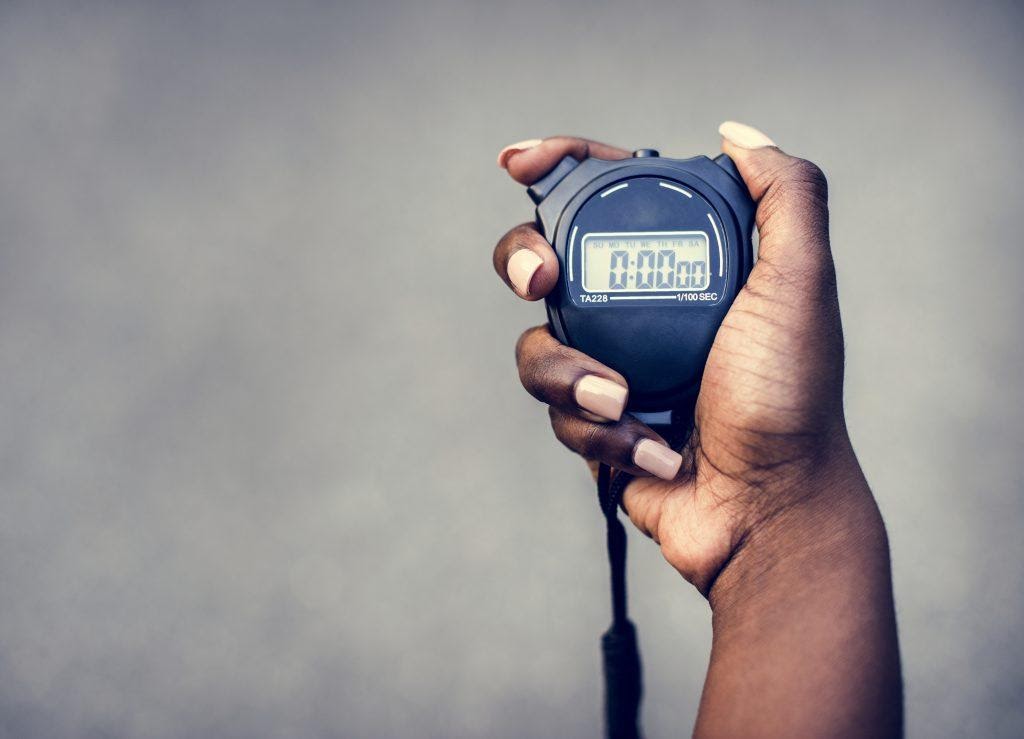 A person holding a stopwatch.