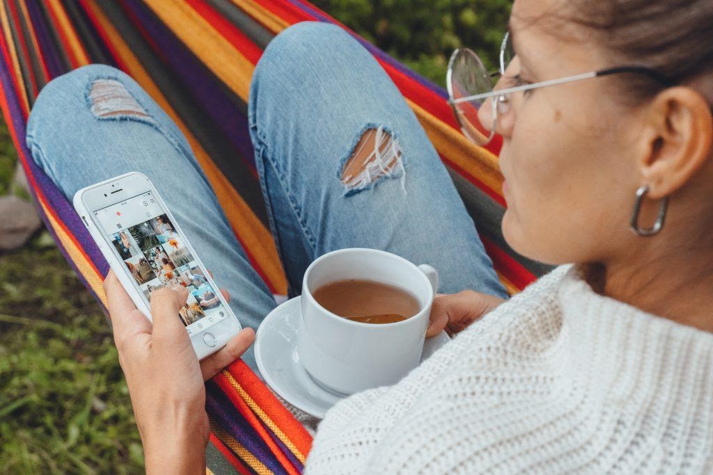 A person cassually viewing Instagram on their phone.