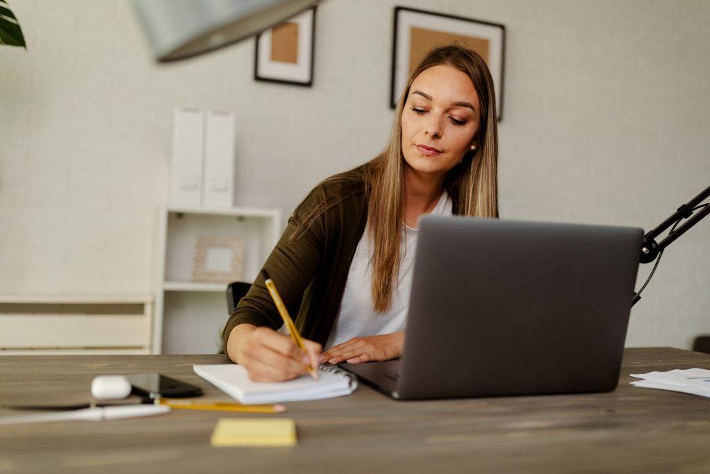 A woman doing research on her laptop.