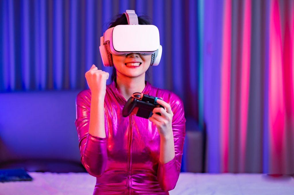 A girl wearing VR goggles while playing a game on a console.