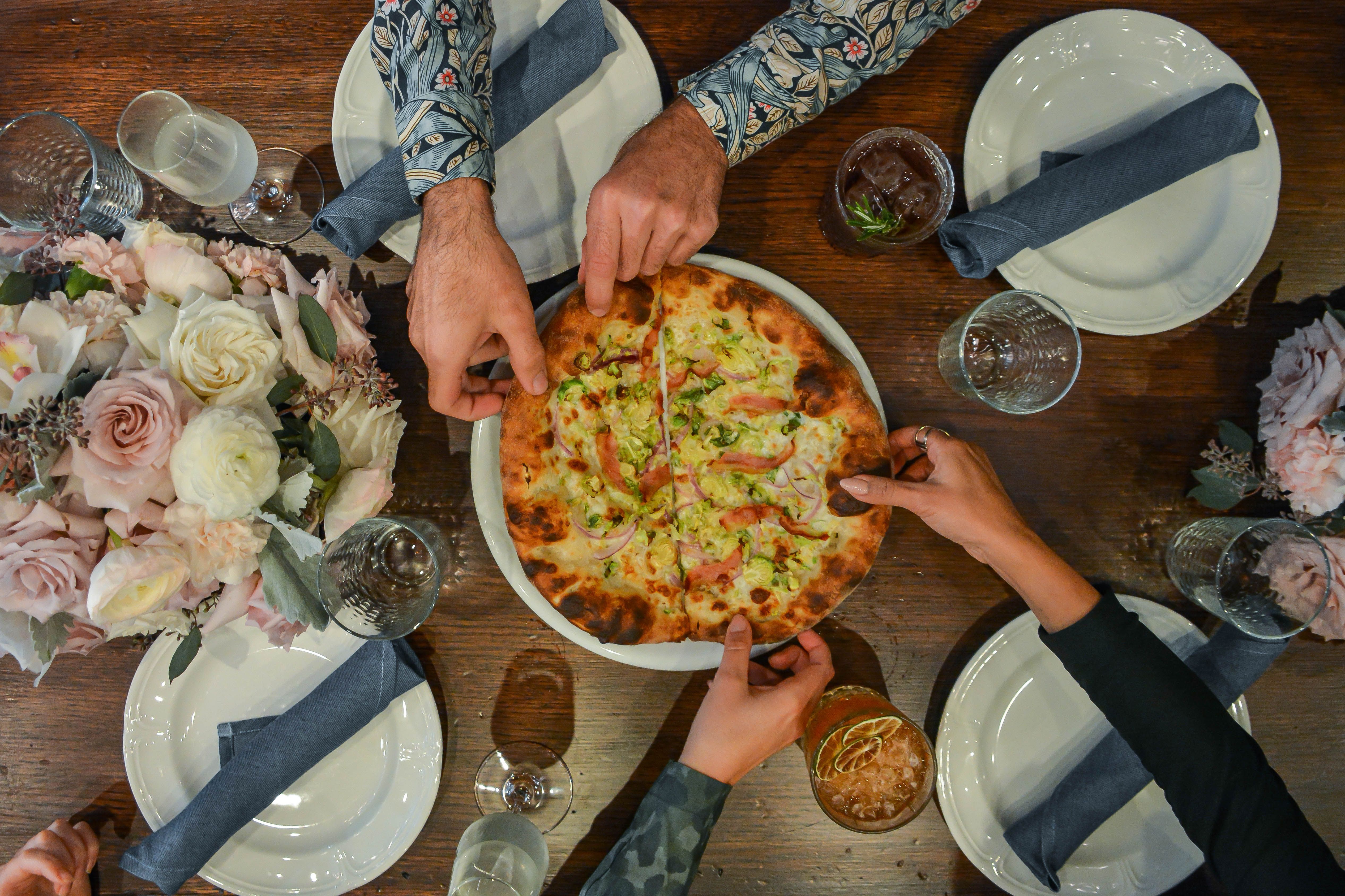 Guests enjoying pizza at Alla Vita. 