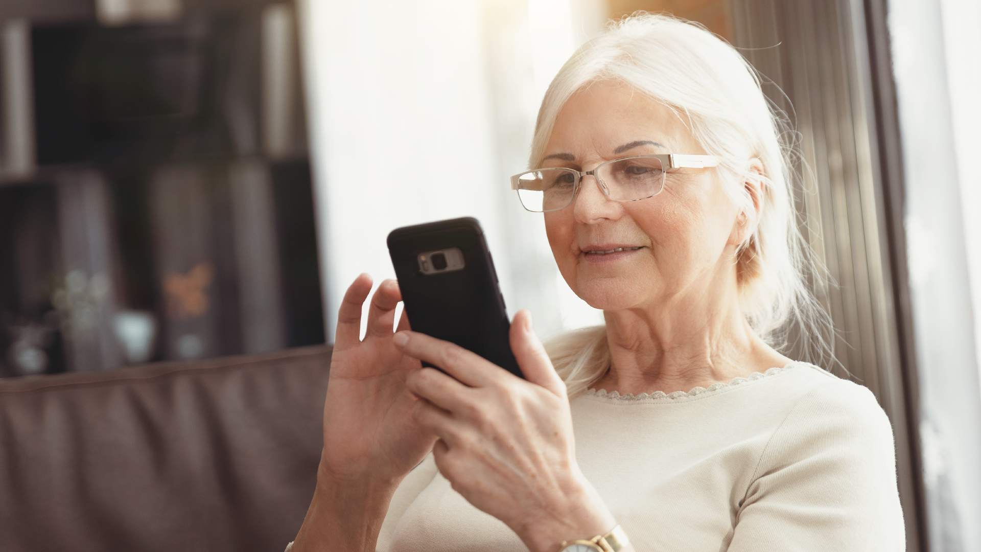 A senior woman using a smartphone to review any messages about her latest medical visit.